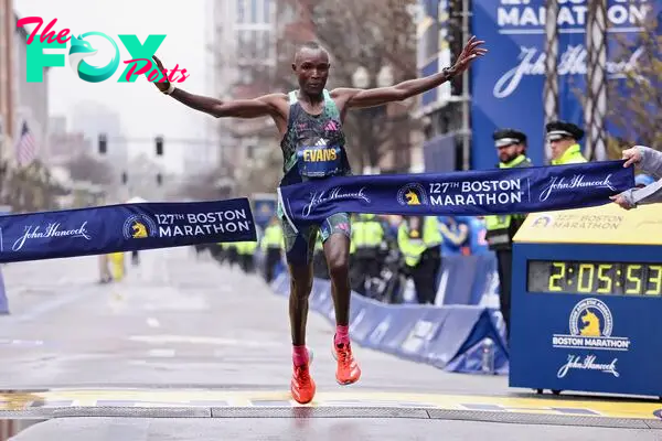 Evans Chebet of Kenya crosses the finish line and takes first place in the professional Men's Division during the 127th Boston Marathon