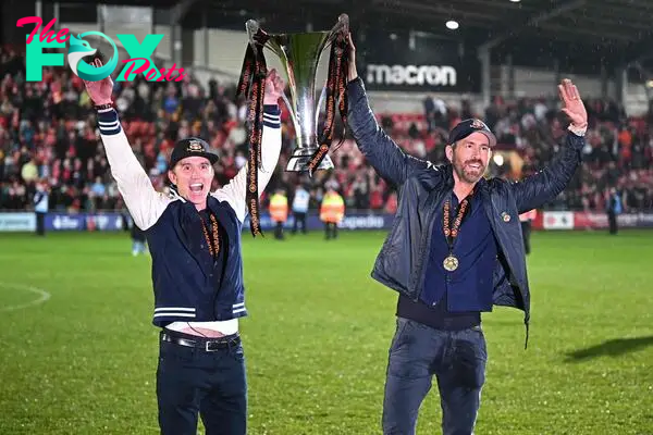 US actor and Wrexham owner Rob McElhenney (L) and US actor and Wrexham owner Ryan Reynolds (R) celebrate