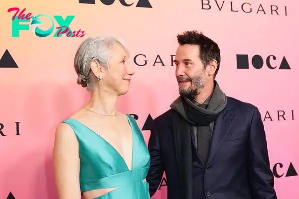 Alexandra Grant and Keanu Reeves posing together 