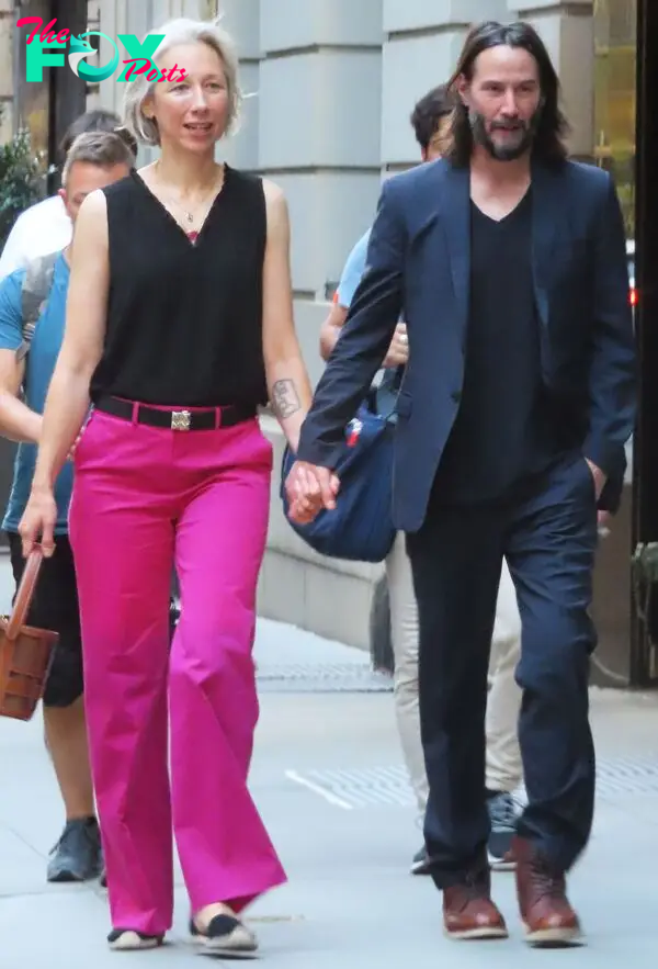 Keanu Reeves and Alexandra Grant walking together 