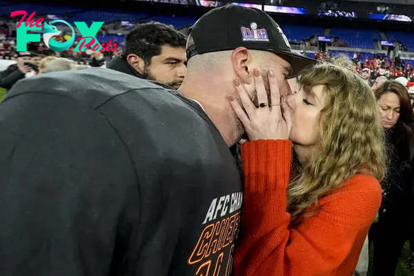 Taylor Swift kisses Kansas City Chiefs tight end Travis Kelce after an AFC Championship NFL football game against the Baltimore Ravens, Sunday, Jan. 28, 2024, in Baltimore.