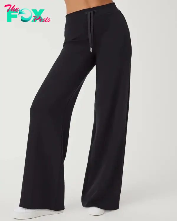 A model in black Spanx pants