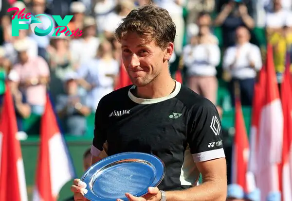 Second placed Norway's Casper Ruud celebrates with his trophy at the end of the Monte Carlo ATP Masters Series Tournament final tennis match on the Rainier III court at the Monte Carlo Country Club.