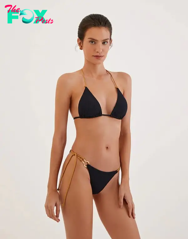A model in a black T-back bikini