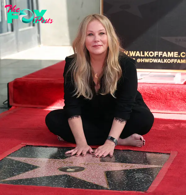 christina applegate squatting in front of her hollywood walk of fame star