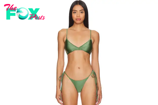 A model in a shiny green bikini