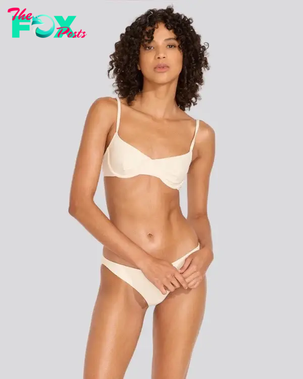 A model in a cream colored bikini