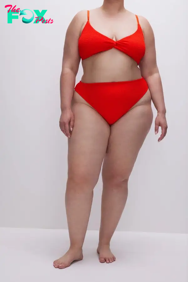 A model in a red high-waisted bikini
