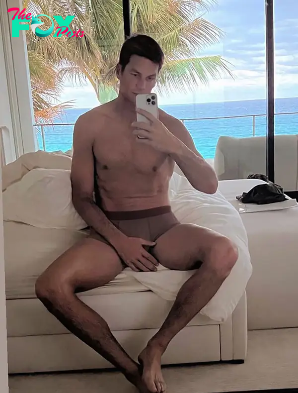 shirtless tom brady sitting on his bed in his underwear