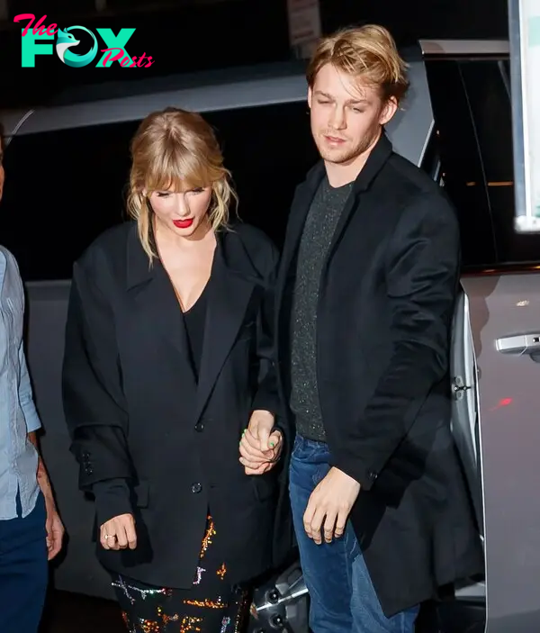 Joe Alwyn and Taylor Swift holding hands. 