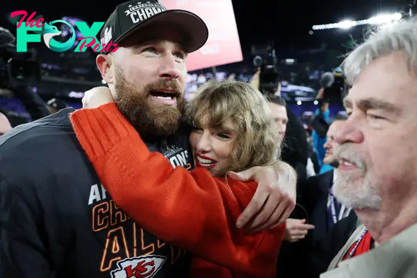 Taylor Swift hugging Travis Kelce with his dad, Ed Kelce, to the side.