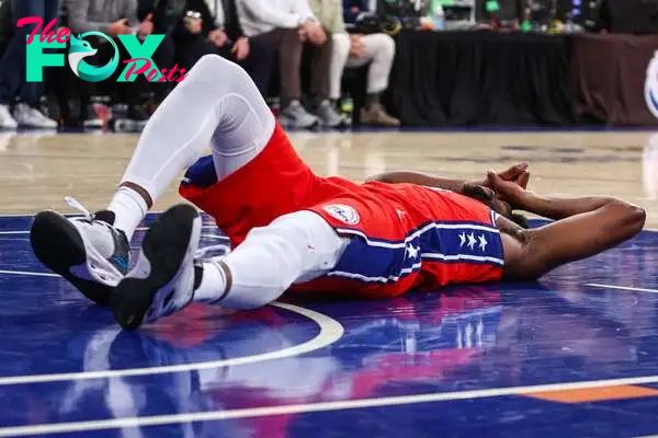 Philadelphia 76ers center Joel Embiid (21) lays on the court after getting injured in the second quarter.