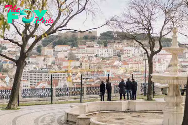 People taking in a view of Lisbon's cityscape