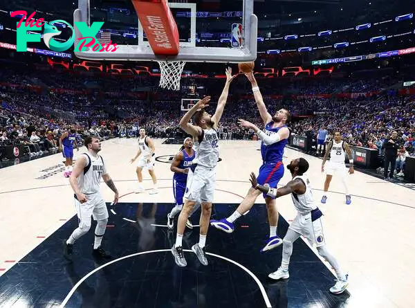 vica Zubac #40 of the LA Clippers takes a shot against Maxi Kleber #42 of the Dallas Mavericks in the second half during game one of the Western Conference First Round Playoffs at Crypto.com Arena on April 21, 2024 in Los Angeles, California.