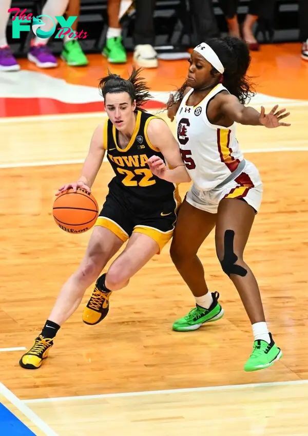 Caitlin Clark playing basketball. 