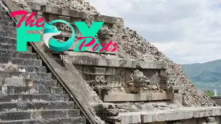 An aerial view of a Maya pyramid with exterior stairs