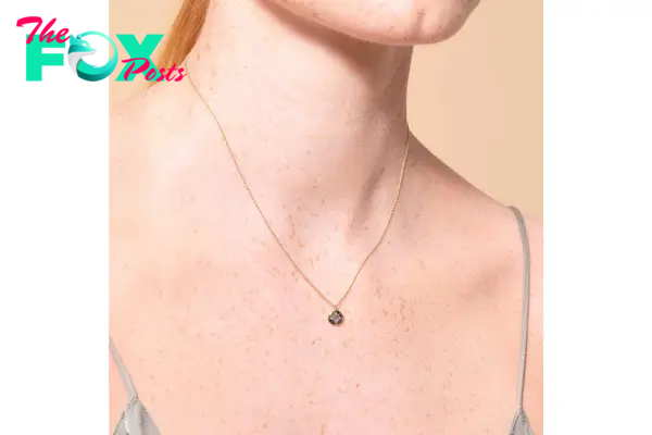 A model wearing a delicate chain necklace