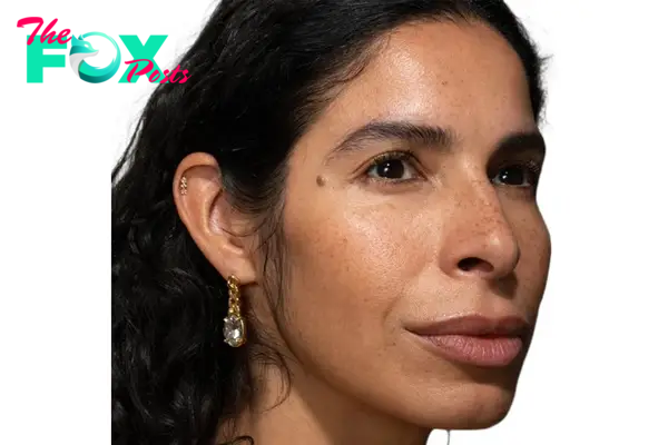 A model in Alexis Bittar earrings