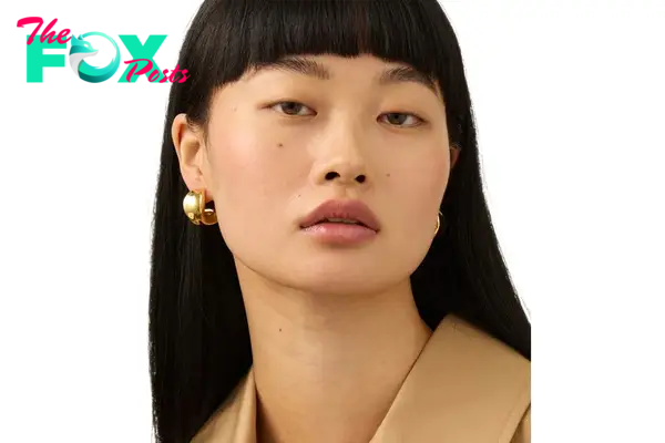 A model in gold hoop earrings