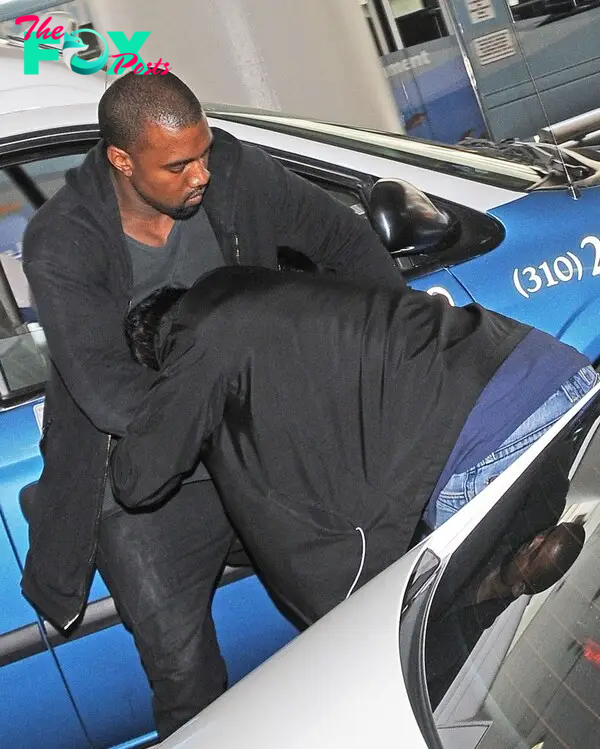 Kanye West fighting with a paparazzo.