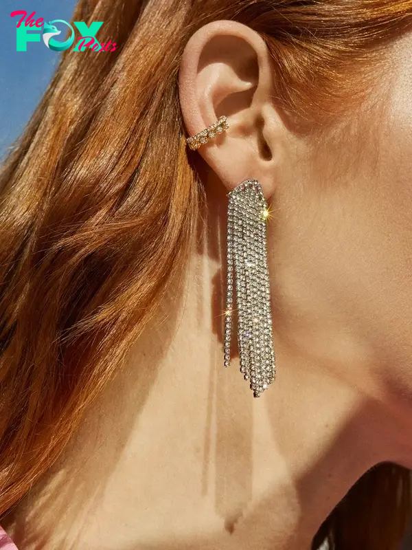 A model in long sparkly earrings