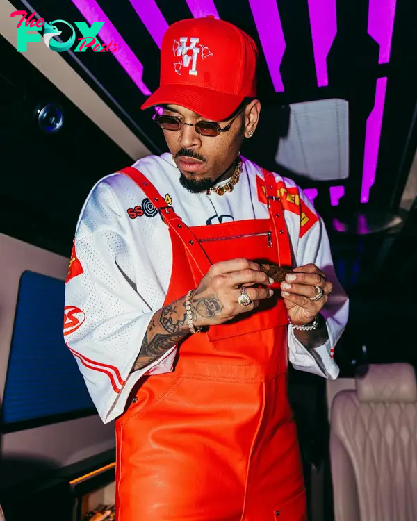 Chris Brown wearing red overalls.