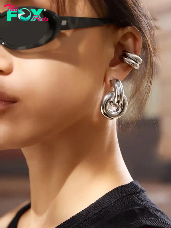 A model wearing silver earrings