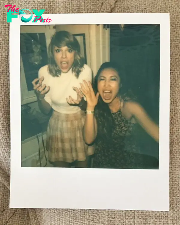 Cassey Ho and Taylor Swift posing for a Polaroid