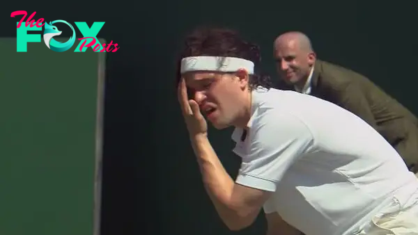 Kit Harington wipes sweat from his face with a pained expression, wearing tennis gear in 7 Days in Hell