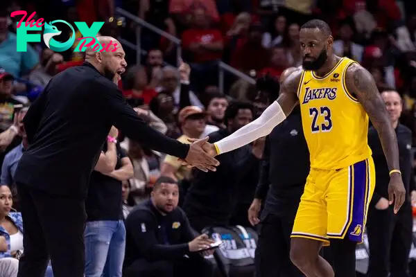 Lakers forward LeBron James reacts with head coach Darvin Ham.