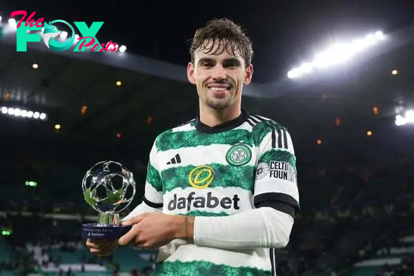 Matt O'Riley of Celtic poses for a photo with the PlayStation Player Of The Match award after the draw in the UEFA Champions League match between C...