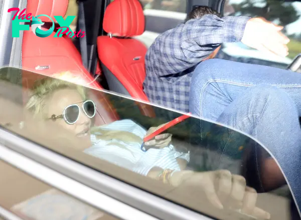 Britney Spears and Richard Soliz sitting in a car
