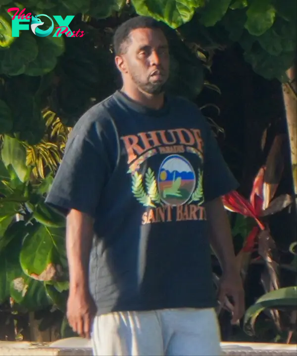 Sean "Diddy" Combs walking outside his home after the raid.