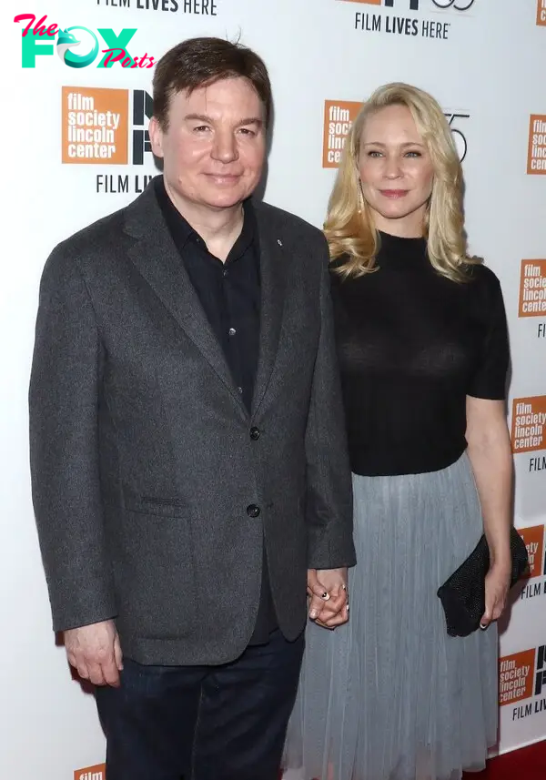 Mike Myers holding hands with his wife Kelly Tisdale.