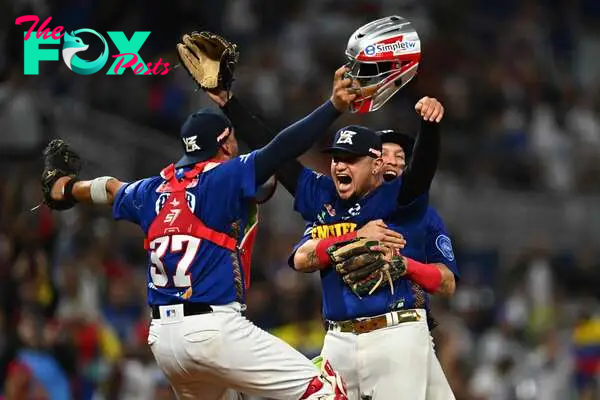 Venezuela's players celebrate after winning the Caribbean Series baseball game against Nicaragua and reaching the semi-finals at LoanDepot Park in Miami, Florida, on February 7, 2024. (Photo by Chandan Khanna / AFP)
