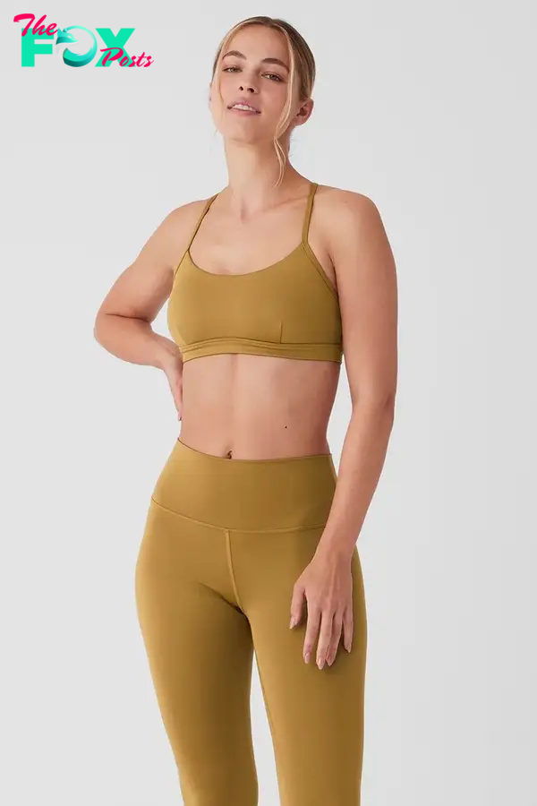 A model in a yellow bra and leggings