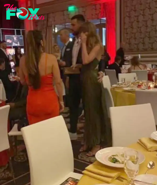 Travis Kelce and Taylor Swift standing together at a gala