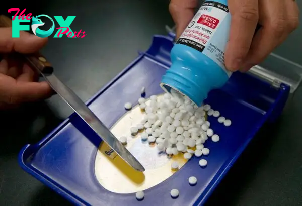 Pills empties onto a tray from a bottle