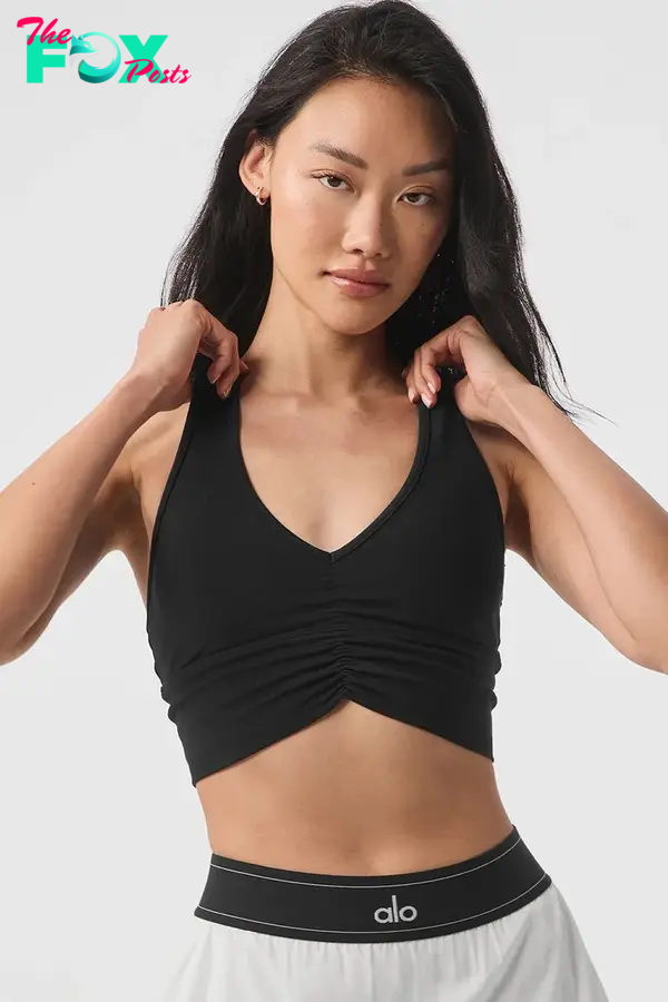 A model in a black ruched bra