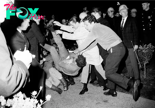 New York City plainclothes policemen drop a student protester on the ground after he and others holding a sit-in at a Columbia University building were removed, April 30, 1968.