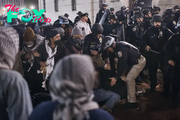 Police remove and arrest protestors outside of Hamilton Hall, April 30, 2024.