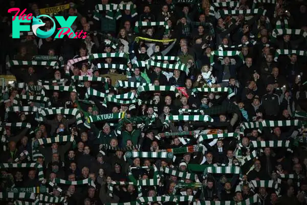 Celtic fans hold their scarves during the singing of 'You'll never walk alone' during the UEFA Champions League group F match between Celtic FC and...