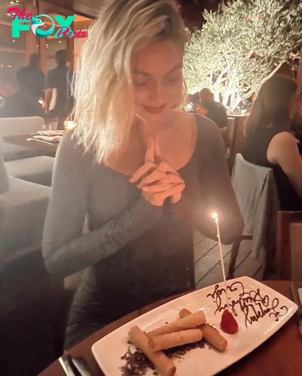 Gigi Hadid making a birthday wish on a candle. 