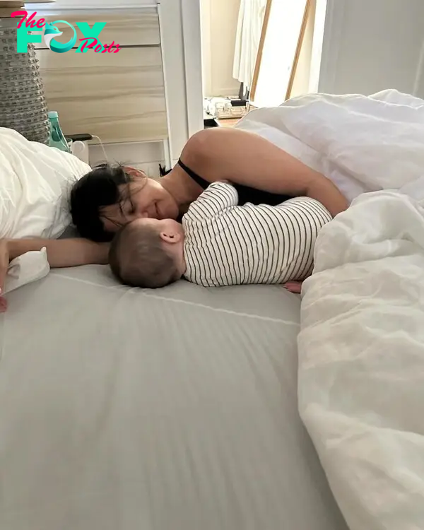 Kourtney Kardashian in bed with baby Rocky. 
