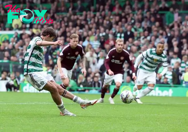 Matt O'Riley of Celtic scores his team's third goal from the penalty spot during the Cinch Scottish Premiership match between Celtic FC and Heart o...