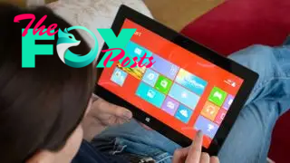 A woman using the Microsoft Surface RT tablet.