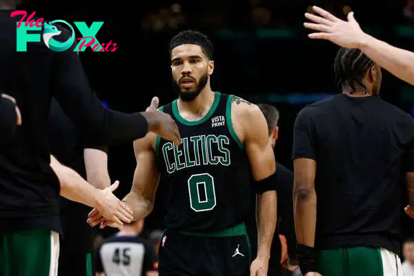 May 1, 2024; Boston, Massachusetts, USA; Boston Celtics forward Jayson Tatum (0) is congratulated by teammates during a timeout during the third quarter of game five of the first round of the 2024 NBA playoffs against the Miami Heat at TD Garden. Mandatory Credit: Winslow Townson-USA TODAY Sports