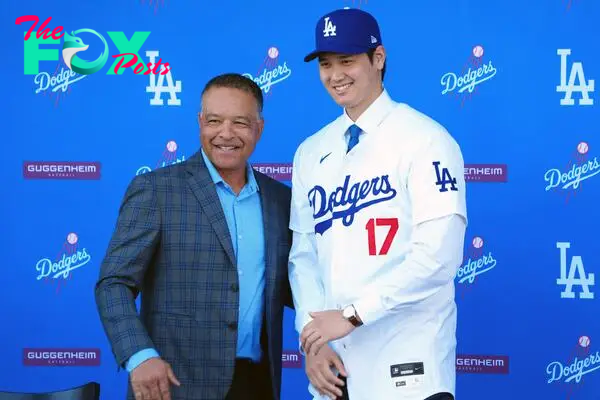 Dec 14, 2023; Los Angeles, CA, USA; Los Angeles Dodgers designated hitter Shohei Ohtani (17) poses with manager Dave Roberts at Ohtani's introductory press conference at Dodger Stadium. Mandatory Credit: Kirby Lee-USA TODAY Sports