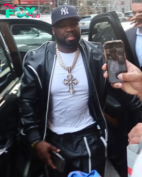 50 Cent getting out of a car.