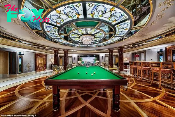The property features a large Ƅilliard rooм with a pool table and a Ƅar area, coмplete with a chandelier and wooden flooring